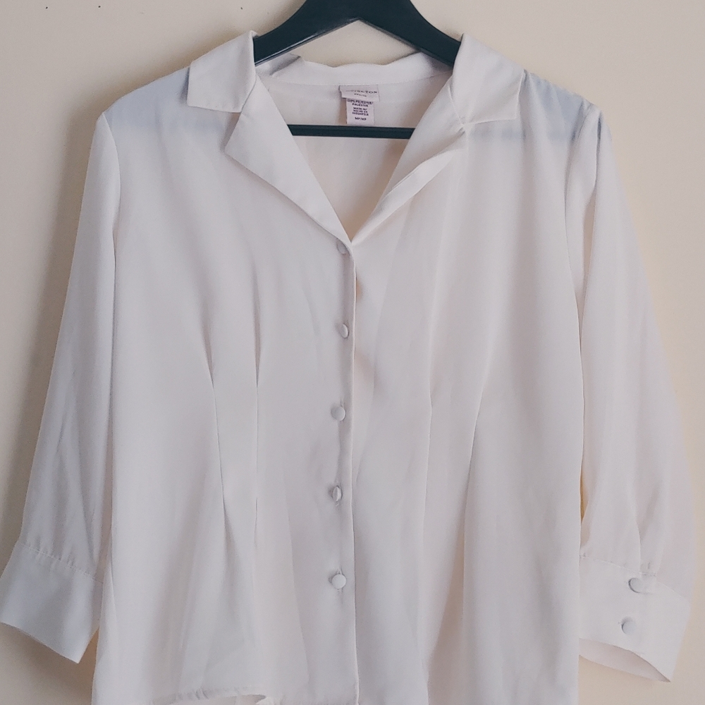An offwhite button up blouse.
